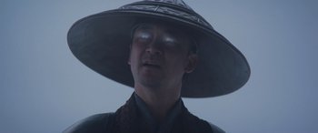 Movie still from “Mortal Kombat” (2021), directed by Simon McQuoid – A man wearing a hat with a light shining on it's face; Close Up shot, Low angle