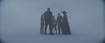 Movie still from “Mortal Kombat” (2021), directed by Simon McQuoid – A group of people standing in the middle of a foggy area; Wide shot, Low angle