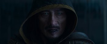Movie still from “Mortal Kombat” (2021), directed by Simon McQuoid – A person wearing a hooded jacket; Close Up shot, Over the shoulder angle