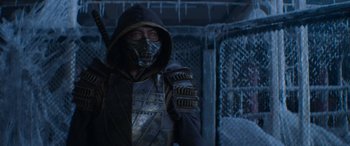 Movie still from “Mortal Kombat” (2021), directed by Simon McQuoid – A man wearing a metal mask and a black jacket; Medium shot, Over the shoulder angle