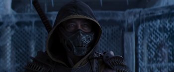 Movie still from “Mortal Kombat” (2021), directed by Simon McQuoid – A man wearing a mask and holding a gun; Close Up shot, Over the shoulder angle