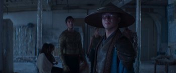 Movie still from “Mortal Kombat” (2021), directed by Simon McQuoid – A group of people standing in a room; Medium shot, Over the shoulder angle