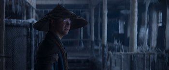 Movie still from “Mortal Kombat” (2021), directed by Simon McQuoid – A man wearing a hat with a light shining on it's face; Close Up shot, Low angle