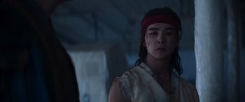 Movie still from “Mortal Kombat” (2021), directed by Simon McQuoid – A man with a red bandanna on his head; Close Up shot, Over the shoulder angle