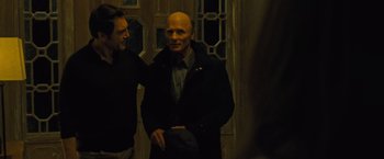 Movie still from “Mother!” (2017), directed by Darren Aronofsky – Two men standing next to each other in front of a building; Medium shot, Over the shoulder angle