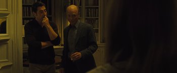 Movie still from “Mother!” (2017), directed by Darren Aronofsky – A man with a bald head is standing in a room; Medium shot, Over the shoulder angle