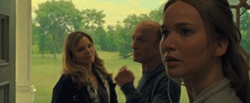 Movie still from “Mother!” (2017), directed by Darren Aronofsky – A group of people standing next to each other in a field; Close Up shot, Over the shoulder angle