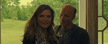 Movie still from “Mother!” (2017), directed by Darren Aronofsky – A man and a woman pose for a picture; Close Up shot, Over the shoulder angle