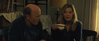 Movie still from “Mother!” (2017), directed by Darren Aronofsky – A man and a woman sitting at a table with a cup of coffee; Medium shot, Over the shoulder angle