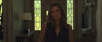 Movie still from “Mother!” (2017), directed by Darren Aronofsky – A woman standing in front of stained glass windows; Medium shot, Over the shoulder angle