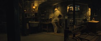 Movie still from “Mother!” (2017), directed by Darren Aronofsky – A person in a room with a sink and counter; Wide shot, High angle