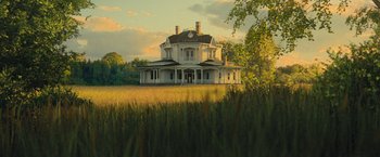 Movie still from “Mother!” (2017), directed by Darren Aronofsky – An old white house sitting in the middle of a field; Extreme Wide shot, Low angle