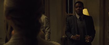 Movie still from “Mother!” (2017), directed by Darren Aronofsky – A man in a suit and tie standing in front of a mirror; Medium shot, Over the shoulder angle