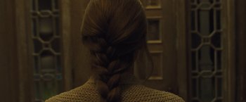 Movie still from “Mother!” (2017), directed by Darren Aronofsky – A person's hair in a braid; Close Up shot, Over the shoulder angle