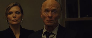 Movie still from “Mother!” (2017), directed by Darren Aronofsky – An older man in a suit and tie looking sad; Close Up shot, Low angle