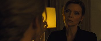 Movie still from “Mother!” (2017), directed by Darren Aronofsky – A woman looking in the mirror while holding a cigarette in her mouth; Close Up shot, Over the shoulder angle
