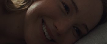 Movie still from “Mother!” (2017), directed by Darren Aronofsky – A smiling child's face; Extreme Close Up shot, Overhead angle