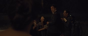 Movie still from “Mother!” (2017), directed by Darren Aronofsky – A group of people standing next to each other in the dark; Medium shot, Over the shoulder angle