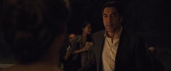 Movie still from “Mother!” (2017), directed by Darren Aronofsky – A group of people standing next to each other in the dark; Medium shot, Over the shoulder angle