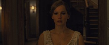 Movie still from “Mother!” (2017), directed by Darren Aronofsky – A woman in a white dress is staring straight ahead; Close Up shot, Over the shoulder angle