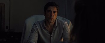 Movie still from “Mother!” (2017), directed by Darren Aronofsky – A person sitting in a chair wearing a dress shirt; Close Up shot, Over the shoulder angle