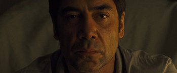 Movie still from “Mother!” (2017), directed by Darren Aronofsky – A man's face in a dimly - lit room; Close Up shot, Low angle