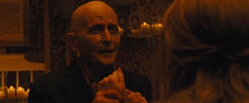 Movie still from “Mother!” (2017), directed by Darren Aronofsky – An old man with a bald head and a long neck; Close Up shot, Over the shoulder angle