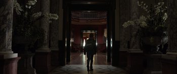 Movie still from “Mr. Harrigan's Phone” (2022), directed by John Lee Hancock – A person is walking through a hallway in a building; Wide shot, Low angle