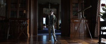 Movie still from “Mr. Harrigan's Phone” (2022), directed by John Lee Hancock – A man standing in a room holding a cane; Wide shot, Low angle