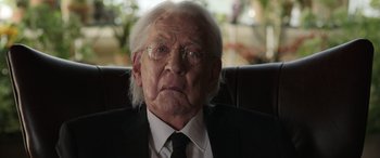 Movie still from “Mr. Harrigan's Phone” (2022), directed by John Lee Hancock – An old man wearing a suit and tie; Close Up shot, Over the shoulder angle