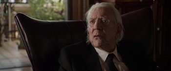 Movie still from “Mr. Harrigan's Phone” (2022), directed by John Lee Hancock – An older man in a suit sitting in a chair; Close Up shot, Over the shoulder angle