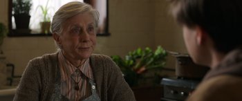 Movie still from “Mr. Harrigan's Phone” (2022), directed by John Lee Hancock – An older woman sitting in front of a window; Close Up shot, Over the shoulder angle