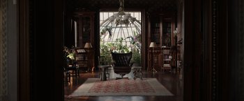 Movie still from “Mr. Harrigan's Phone” (2022), directed by John Lee Hancock – A living room filled with furniture next to a large window; Wide shot, High angle