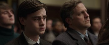 Movie still from “Mr. Harrigan's Phone” (2022), directed by John Lee Hancock – A man in a suit and tie sitting next to another man in a suit and tie; Close Up shot, Over the shoulder angle