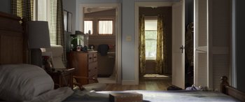 Movie still from “Mr. Harrigan's Phone” (2022), directed by John Lee Hancock – A room with a dresser and a chair in it; Wide shot, High angle