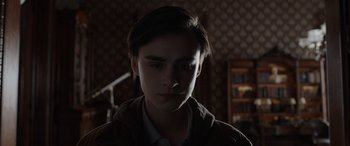 Movie still from “Mr. Harrigan's Phone” (2022), directed by John Lee Hancock – A young man is looking at the camera; Close Up shot, Low angle