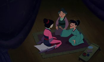 Movie still from “Mulan” (1998), directed by Tony Bancroft – A group of women sitting on the ground in a room; Wide shot, High angle