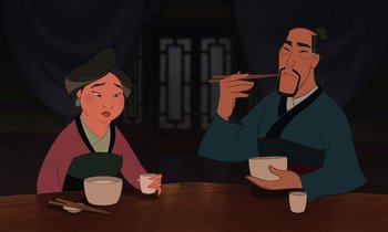 Movie still from “Mulan” (1998), directed by Tony Bancroft – An animated scene of a man and woman eating food; Medium shot, Low angle