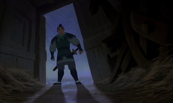 Movie still from “Mulan” (1998), directed by Tony Bancroft – A man standing in the middle of a tunnel in the rain; Medium shot, Over the shoulder angle