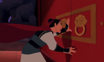 Movie still from “Mulan” (1998), directed by Tony Bancroft – A man with a long black and red hair and a long black and red cape; Medium shot, Over the shoulder angle
