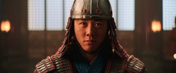 Movie still from “Mulan” (2020), directed by Niki Caro – A man wearing a helmet and a blue shirt; Close Up shot, Low angle