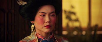 Movie still from “Mulan” (2020), directed by Niki Caro – A person wearing a costume; Close Up shot, Over the shoulder angle