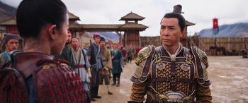 Movie still from “Mulan” (2020), directed by Niki Caro – A group of people in traditional chinese garb; Medium shot, Over the shoulder angle