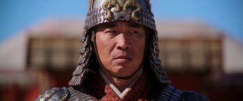 Movie still from “Mulan” (2020), directed by Niki Caro – A person wearing a helmet; Close Up shot, Low angle