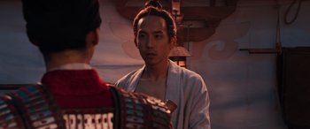 Movie still from “Mulan” (2020), directed by Niki Caro – A man wearing a robe and a red robe; Close Up shot, Over the shoulder angle