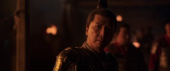 Movie still from “Mulan” (2020), directed by Niki Caro – A person wearing a costume; Close Up shot, Over the shoulder angle