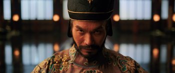 Movie still from “Mulan” (2020), directed by Niki Caro – A person wearing a hat; Close Up shot, Low angle