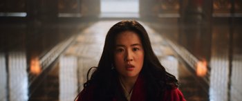 Movie still from “Mulan” (2020), directed by Niki Caro – A woman with long black hair wearing a red robe; Close Up shot, Low angle