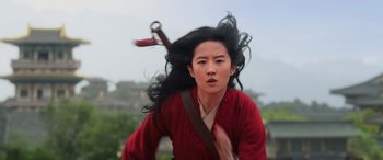 Movie still from “Mulan” (2020), directed by Niki Caro – A woman in a red robe with long black hair; Medium shot, Low angle