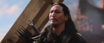 Movie still from “Mulan” (2020), directed by Niki Caro – A person with long hair holding a sword; Close Up shot, Low angle